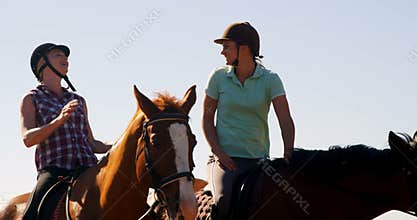 Friends giving high five while riding horse 4k
