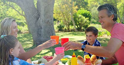Happy family having juice in park 4k
