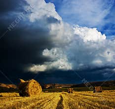 Stormy clouds and bale