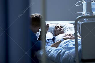Worried daughter supporting dying mother