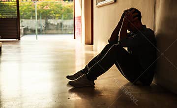 Emotional moment: man sitting holding head in hands, stressed sad young male having mental problems, feeling bad, depressed