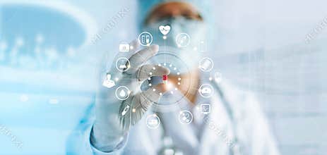 Medicine doctor holding a color capsule pill in hand with icon medical network connection on modern virtual screen interface in la
