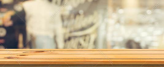 Wooden board empty table top blurred background. Perspective brown wood table over blur in coffee shop background.