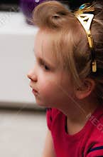 Profile of girl wearing golden crown