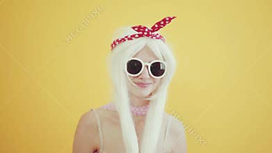 Blond girl with glasses in the image of anime doll