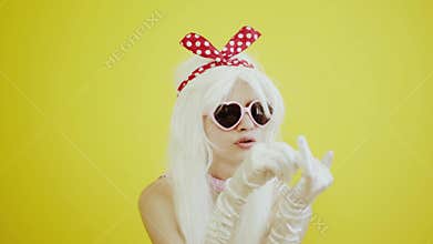 Blond girl with glasses in the image of anime doll