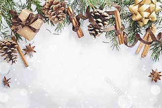 Christmas and New Year composition. Gift box with ribbon, fir branches with cones, star anise, cinnamon on white background