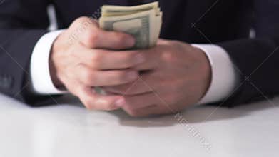 Rich male counting dollar banknotes, hands of businessman estimating income