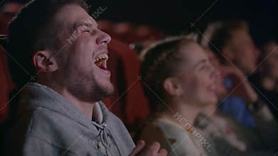 Man laughing at comedy film. Male emotion at movie entertainment