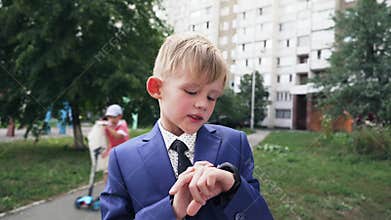Close Up shot of smart watch with black strap on a hand of child in business suit. Sport smart wrist using