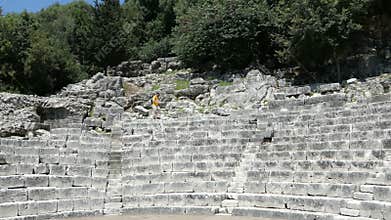 People visiting ruins of amphitheater in Buthrotum Albania of roman and venetian time. Archaeological park. Also known as Butri