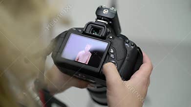Photographer watching photos on camera