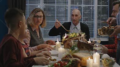 Cheerful family enjoying Thanksgiving day dinner