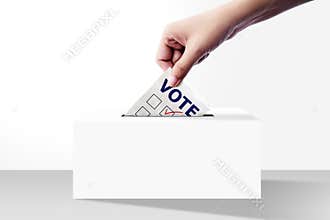 Close up of hand holding voting paper for election vote into box