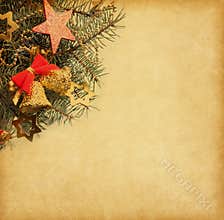 Vintage paper with spruce branch adorned with Christmas decorations