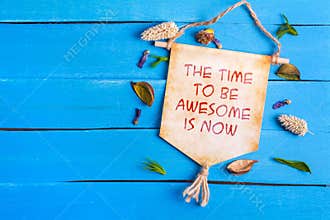 The time to be awesome is now text on Paper Scroll