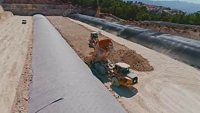 Aerial footage of large highway construction project with tunnels and bridges