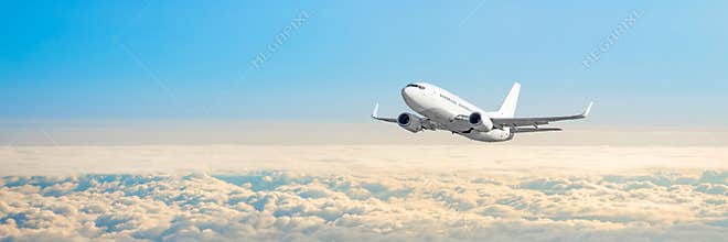 Passenger aircraft cloudscape with white airplane is flying in the daytime sky overcast, panorama view.