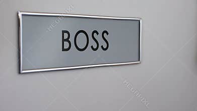 Boss office door, secretary hand knocking closeup, documents for signature