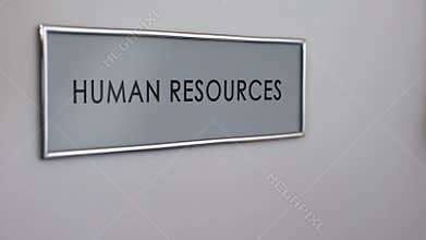 Human resources office door, hand knocking closeup, competition for position