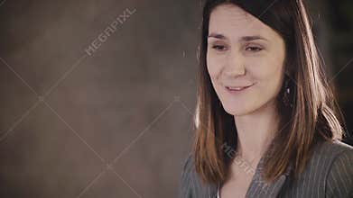 Attractive confident female business coach gives a speech. Young happy Caucasian woman boss speaking at formal meeting.