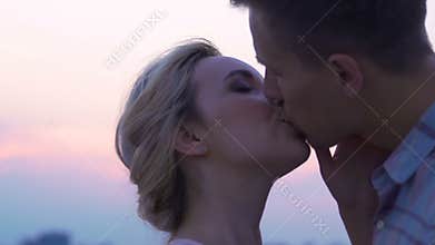 Newlyweds kissing, young lovers on summer date outside, passionate relations