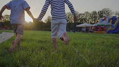 Children running barefoot across the lawn. Fun outdoors