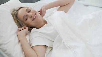 Healthy sleep on orthopedic mattress, happy teenage girl waking up with smile