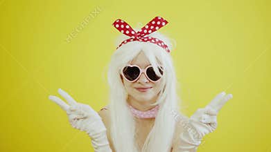 Blond girl with glasses in the image of anime doll