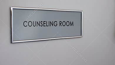 Counseling room door, hand knocking closeup, family therapy, support group