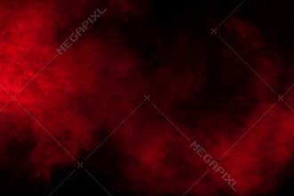 Abstract explosion of red powder on black background