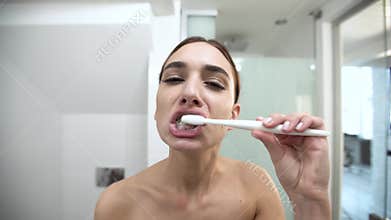Teeth Hygiene. Woman Brushing Teeth And Looking At Camera