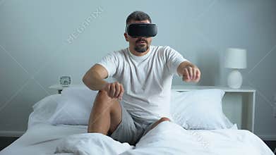 Man passing quest in virtual reality headset, modern technology, pastime at home