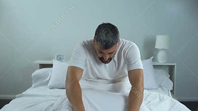 Man trying to wake up in morning, problems with sleep, chronic fatigue syndrome