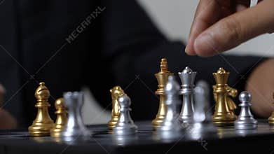 Hand of business man and woman playing chess