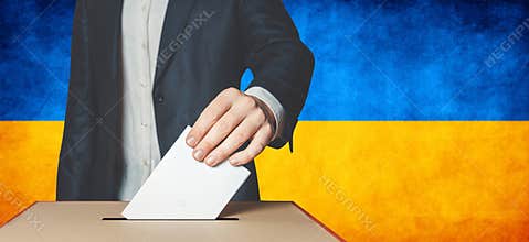 Elections in Ukraine, political struggle. Democracy, freedom and independence concept. Man Voter Putting Ballot In to Voting box