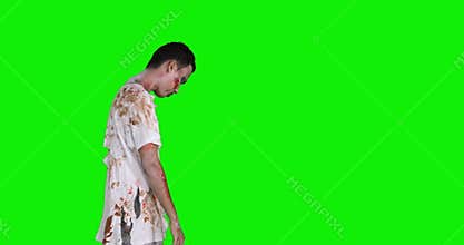 Side view of creepy zombie man walks in studio