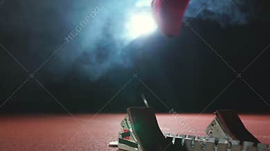 Close-up legs in sneakers athletes are running pads on the track of the sports complex and run in slow motion