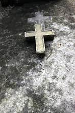 A cross in a old grave in Paris