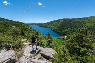 Male hiker enjoying the view of Jordan Pond in Acadia National Park