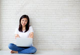 Beautiful of portrait asian young woman excited and glad of success with laptop computer.