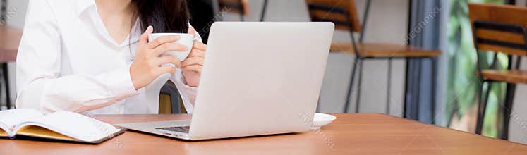 Closeup banner website asian young woman working online on laptop at coffee shop