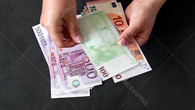 Hands counting euros bills of different values. Euro cash money