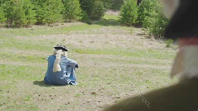 Lonely aristocrat sitting on the grass in the Park. Stock. The concept of loneliness at all times