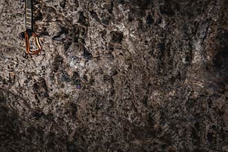 Alpinism carabine of climbing on rough rock wall