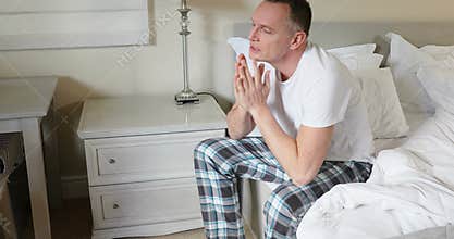 Man sitting on bed after waking up in bedroom 4k