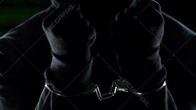 Aggressive bandit trying to break cuffs and set free, crime and punishment