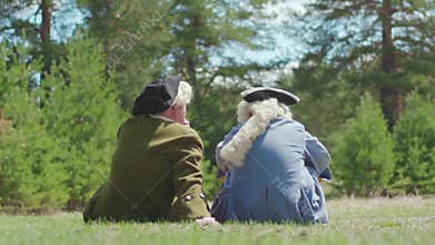 Aristocrats men in the Park. Stock. Two friend aristocrat sitting on the grass in the Park. The concept of nostalgia for
