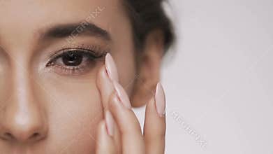 Cute brunette girl posing at gray background