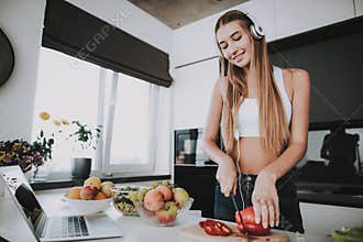 Girl Is Cooking And Listen To Music In Headphones
